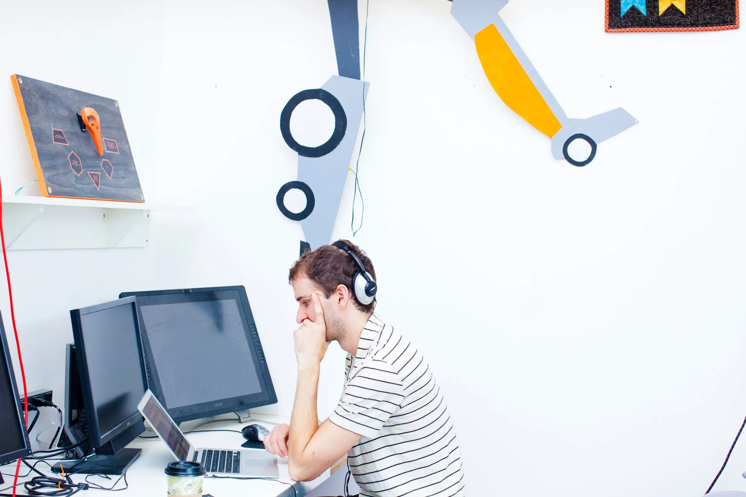 A student working at a laptop in a design studio