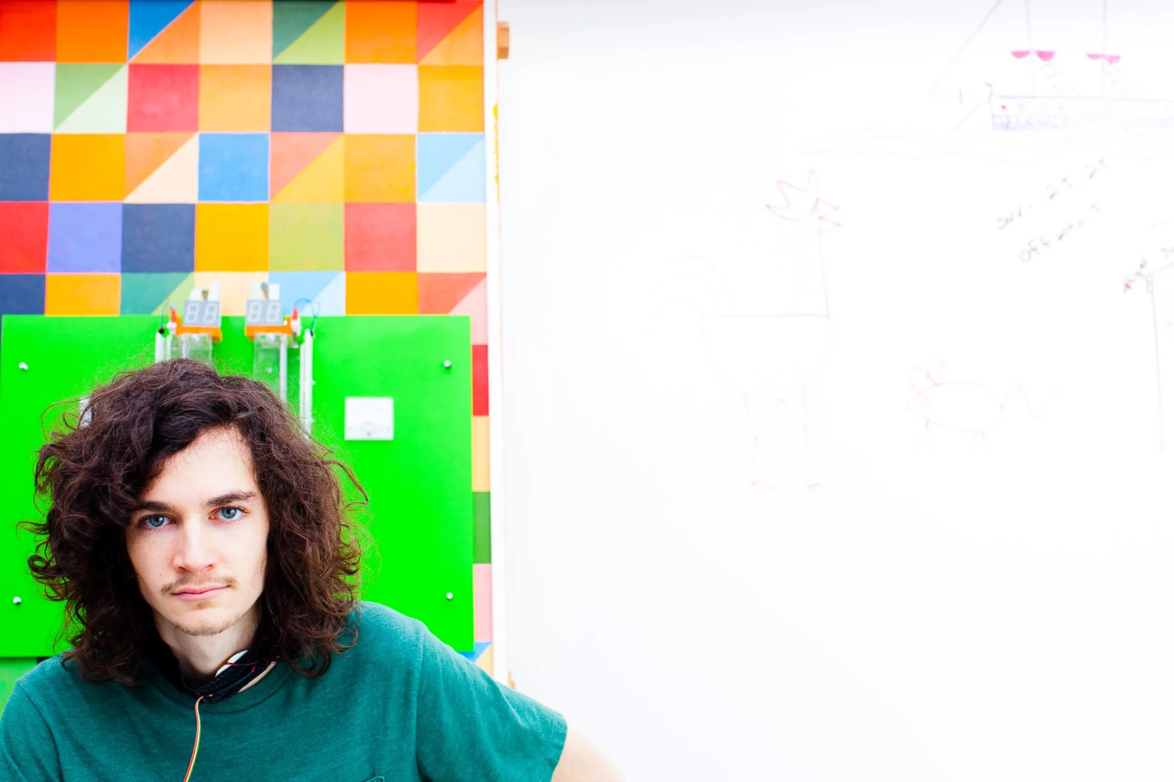 Portrait of a student in front of a colorful painted wall